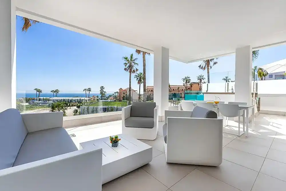 Covered terrace lounge with sea views
